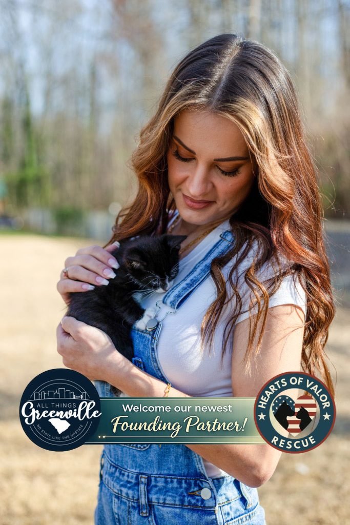 Woman in overalls holding a black kitten outdoors, with "Founding Partner" and rescue logos overlaid.