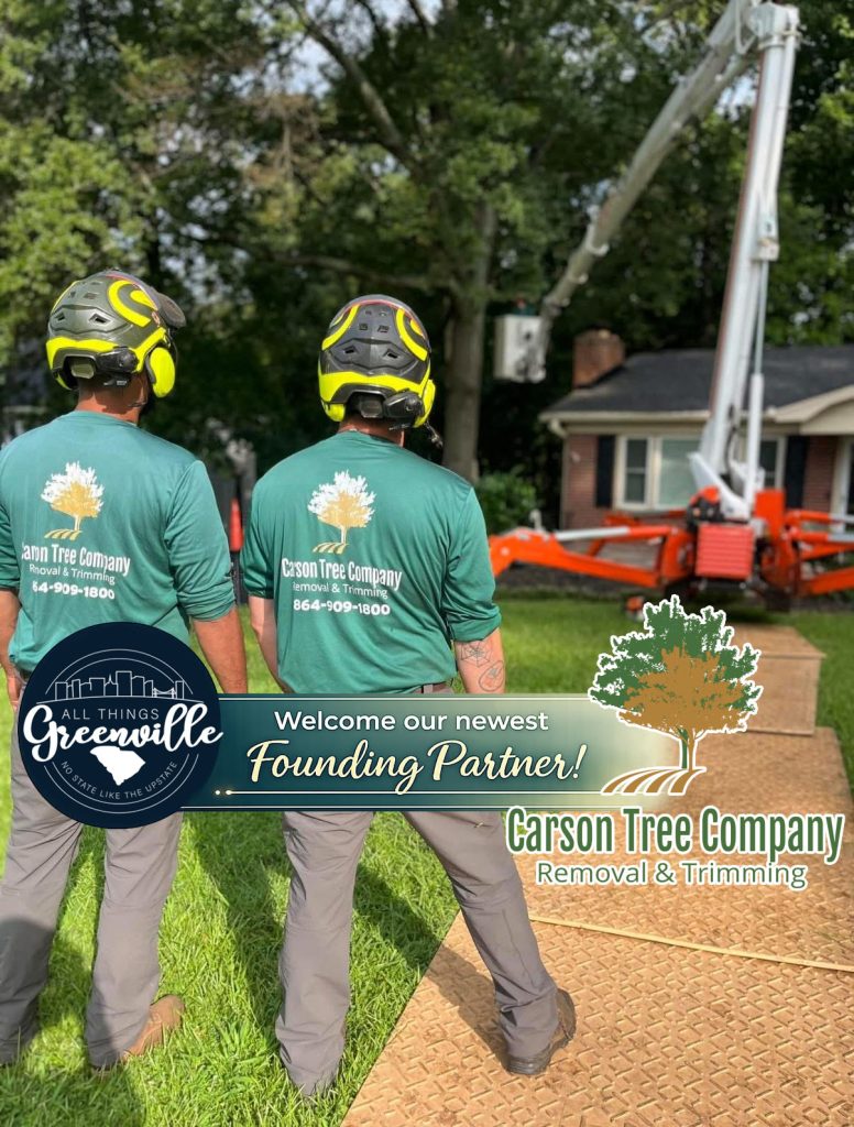 Two tree service workers stand on grass near equipment, with Carson Tree Company logo and partnership banner.