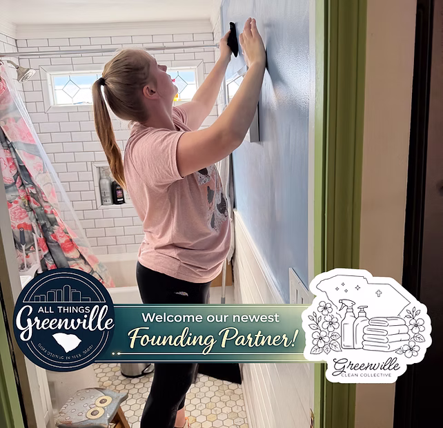 A woman cleans a blue wall in a bathroom; graphic overlay welcomes a new founding partner in Greenville.