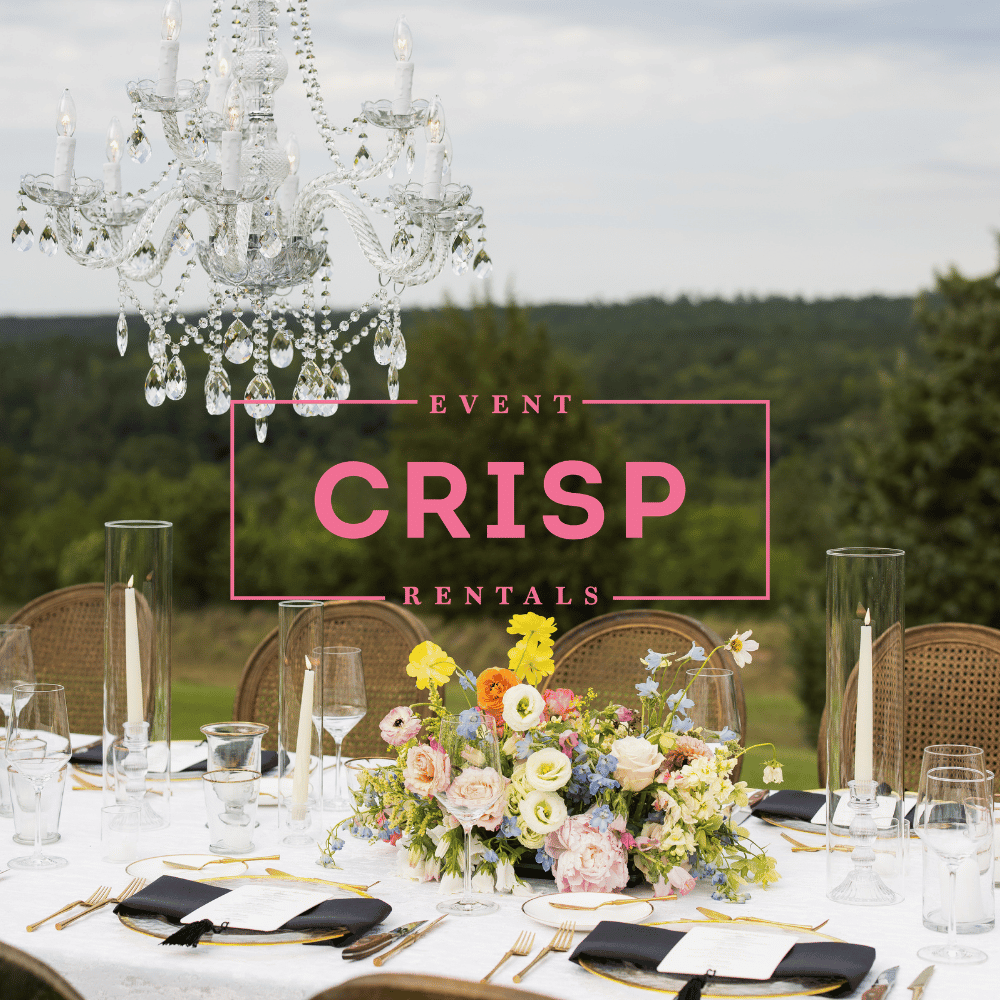 Elegant outdoor table setting with flowers, chandeliers, and "Crisp Event Rentals" text over the image.