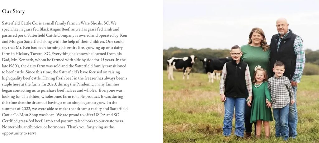 Two children stand in a grassy field with cows behind them under a cloudy sky.